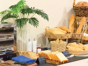 a table filled with bread and baskets of bread at Hotel Faranda Los Tilos, Ascend Hotel Collection in Santiago de Compostela