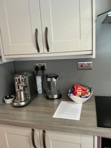 a kitchen counter with a blender and a bowl on it at The Lily Pad - Boutique Townhouse, a short walk to Town Center and Racecourse in Cheltenham
