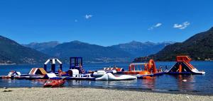 a group of inflatable water rides on a lake at Appartamento AZZURRO in Cannobio