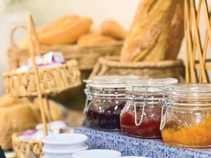 a table with jars of honey and baskets of bread at Hotel Faranda Los Tilos, Ascend Hotel Collection in Santiago de Compostela