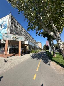 an empty street in front of a building at Bishkek Apartment Central in Bishkek