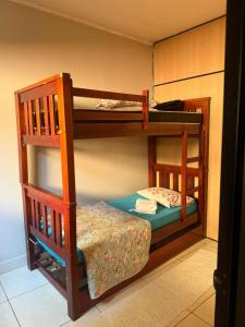 two bunk beds in a room with a small bed at Casa de Gente Feliz in Cuiabá
