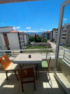 a table and chairs on a balcony with a view at Poli House in Kasaplar