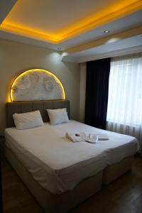 a bedroom with a large bed with two towels on it at Poli House in Kasaplar