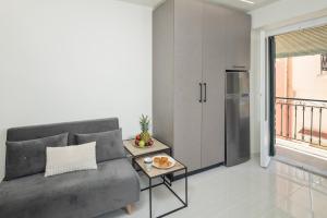 a living room with a couch and a refrigerator at Casa Petridou 2 in Corfu
