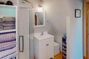 a white bathroom with a sink and a mirror at Mountain Escape in Sturgis +18 photos