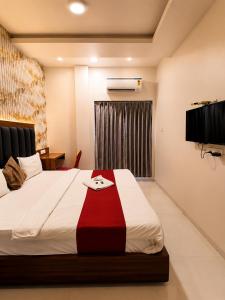 a bedroom with a bed with a red and white blanket at Transit Seven Hills Hotel Near Airport Mumbai T2 in Mumbai
