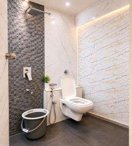 a bathroom with a toilet and a shower at Transit Seven Hills Hotel Near Airport Mumbai T2 in Mumbai +22 photos