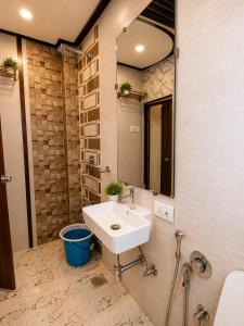 a bathroom with a sink and a mirror at Transit Seven Hills Hotel Near Airport Mumbai T2 in Mumbai