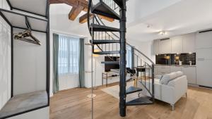 a living room and a staircase in a house at GLANDON Rooms Haldenhof - Self-Check-In in Lucerne