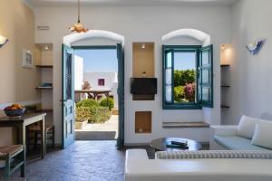 a living room with a couch and a window at Nefeli Hotel Leros in Agia Marina