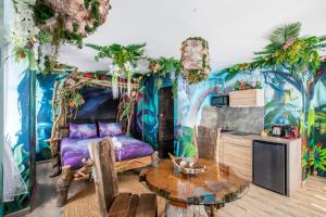 a living room with a purple couch and a table at Avataar - L'arbre de Pandoraa in Belfort
