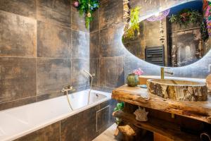 a bathroom with a sink and a tub and a mirror at Avataar - L'arbre de Pandoraa in Belfort +76 photos