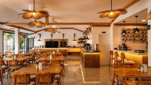 a restaurant with wooden tables and chairs and a counter at Güneş Boutique Hotel - Oludeniz in Oludeniz
