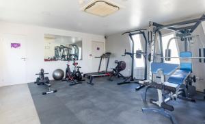 a gym with several exercise equipment in a room at Vacancéole - Le Terral - Montpellier Sud in Saint-Jean-de-Védas