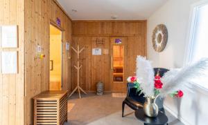 a living room with a chair and a vase with feathers at Vacancéole - Le Terral - Montpellier Sud in Saint-Jean-de-Védas +23 photos