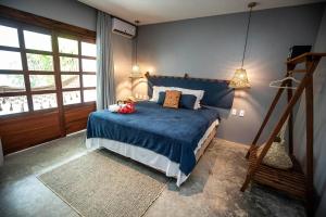 a bedroom with a bed with a blue comforter at Pura Vida Hotel in Itarema +23 photos