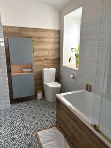 a bathroom with a tub and a toilet and a sink at Azyl na statku 5 in Pardubice