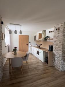 a kitchen and dining room with a table and chairs at Azyl na statku 5 in Pardubice