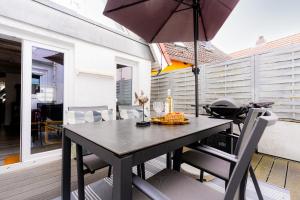 a table with an umbrella on a patio at Haus 1805 Fehmarn in Fehmarn