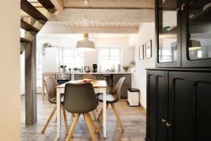 a kitchen and dining room with a table and chairs at Haus 1805 Fehmarn in Fehmarn