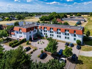 an aerial view of a building with a parking lot at Best Western Spreewald in Lübbenau