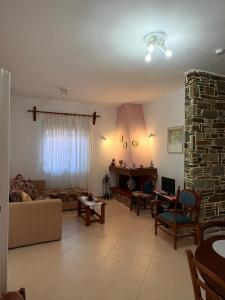 a living room with a couch and a fireplace at House by the sea! in Platamonas