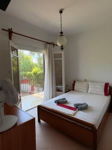a bedroom with a bed with two bags on it at House by the sea! in Platamonas