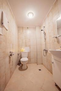 a bathroom with a toilet and a sink at Guest House Elidis in Primorsko