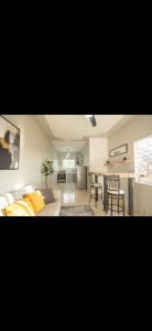 a living room with a couch and a table at Teika comfort in Kingston