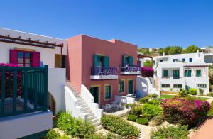a row of houses with colorful balconies and flowers at Nefeli Hotel Leros in Agia Marina