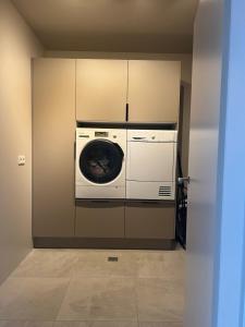 a washer and dryer in a room with a wall at Mistar Home in Gardur +8 photos