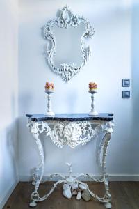 a white console table with a mirror on a wall at Art Studios Gialova Navarino in Gialova