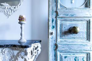 a blue door with a vase of flowers on a table at Art Studios Gialova Navarino in Gialova