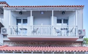 a balcony of a white building with a railing at Art Studios Gialova Navarino in Gialova