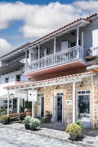 a building with a balcony on top of it at Art Studios Gialova Navarino in Gialova