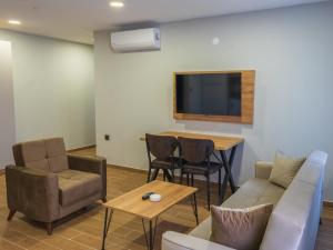 a living room with a couch and a table at Mimoza Apart in Trabzon