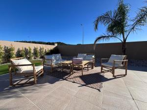 a group of chairs and tables on a patio at La maison da serra in Quinta do Anjo