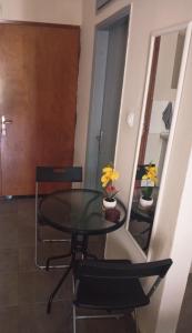a table and chairs in a room with a mirror at ELENAs in Kallithea Halkidikis
