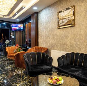 a waiting room with chairs and a table and a mirror at Histavera Hotel in Istanbul
