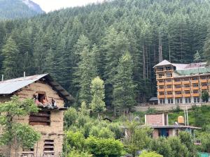 a person sitting on the roof of a house at Whitestone PULGA in Kalgha +16 photos