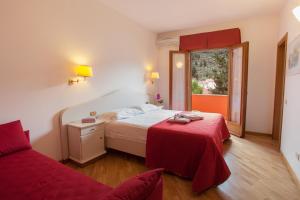 Postel nebo postele na pokoji v ubytování Hotel Le Rotonde