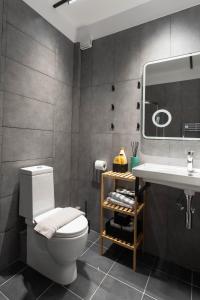 a bathroom with a white toilet and a sink at Azure Residence Koumitsa in Nea Roda +86 photos