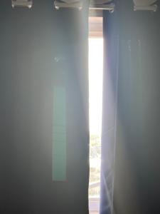 a window with a curtain in a room at Zybnb in Livonia