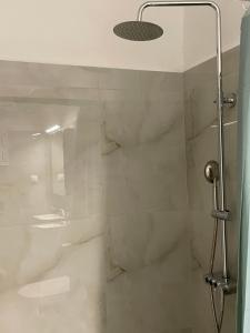 a bathroom with a shower with white marble walls at Epanomi SunSet Loft in Epanomi +27 photos