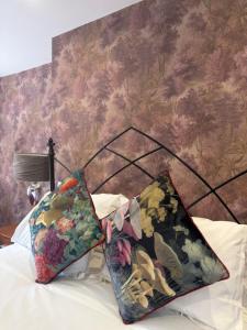 two pillows sitting on top of a bed with a wallpaper at Kip 54 Monks Bar in Portsmouth