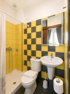 a bathroom with a toilet and a sink and a shower at Hotel Prinos in Skala Prinou +40 photos