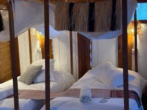 a bedroom with two bunk beds with white pillows at Anchaca Sul in Bubaque