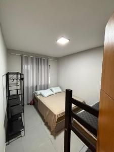 a bedroom with a bed and a ladder in it at Chácara pôr do sol in Araçoiaba da Serra