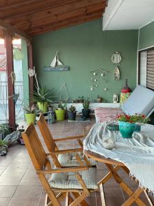 a living room with a table and chairs and plants at Epanomi SunSet Loft in Epanomi